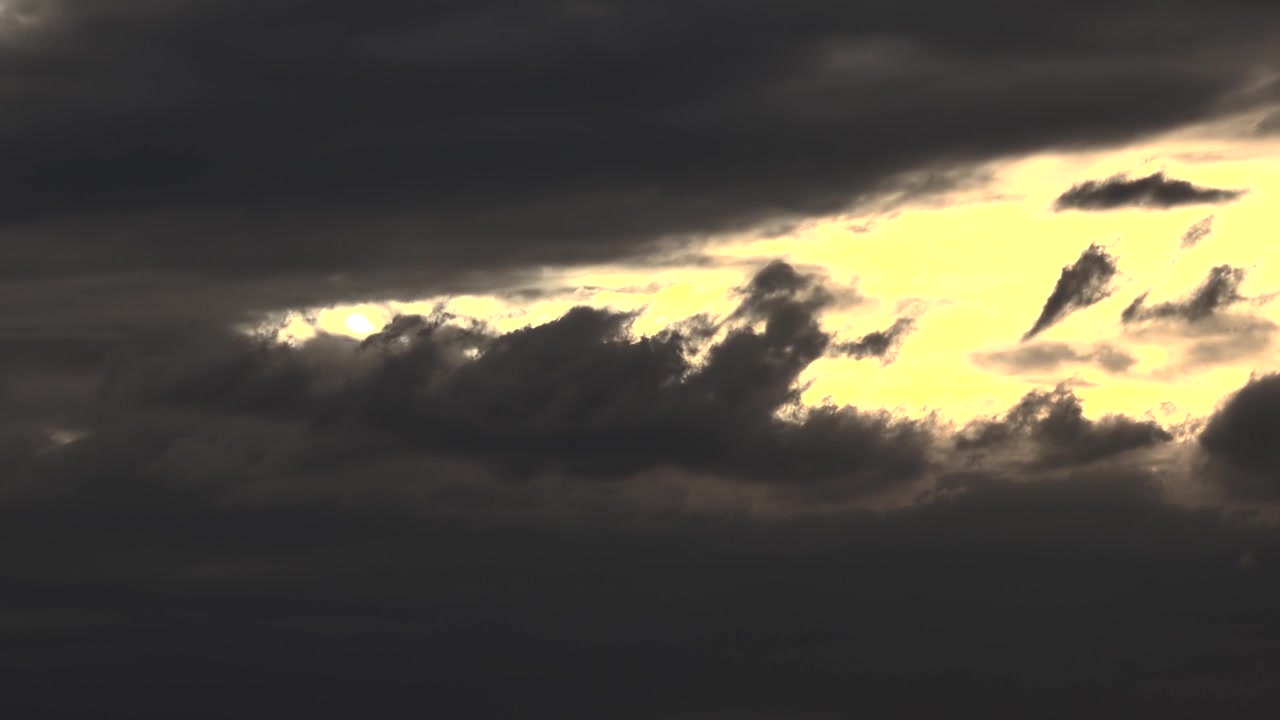 Dark Storm Clouds Moving Across a Bright Yellow Sky