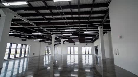 wide-angle video of a spacious, modern industrial interior with polished concrete floors and exposed