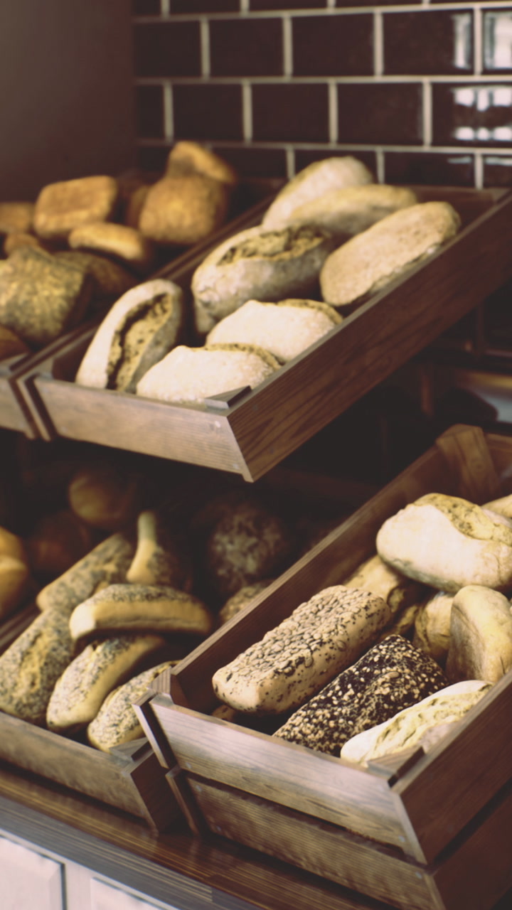 Freshly baked bread displayed in wooden trays at a bakery