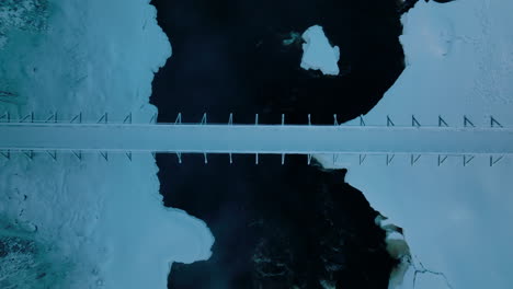 steel bridge covered with snow over vikakongas river at winter