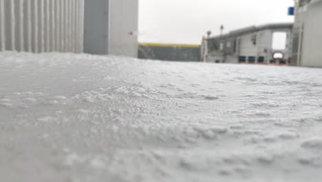 Thick-layer-of-fire-fighting-foam-flowing-over-ships-deck-during-fire-drill---Static-handheld-low-angle-with-foam-close-to-camera---Electric-ferry-Hjellestad-Norway