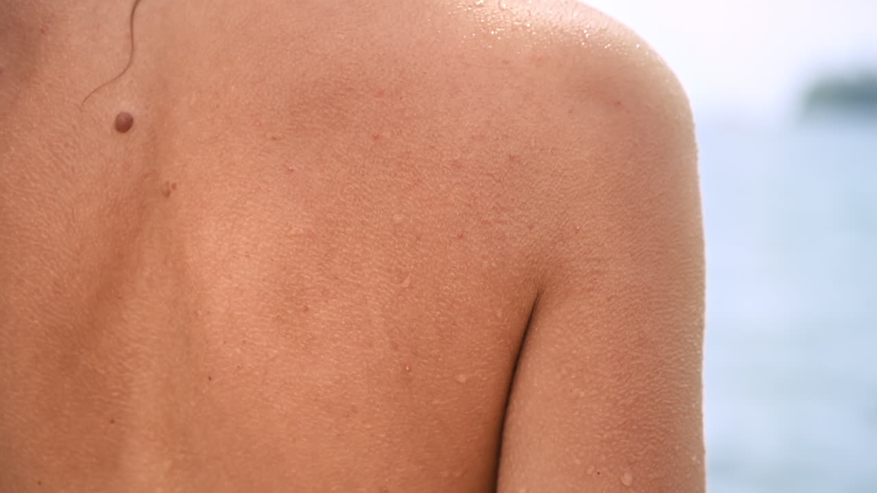 Close view of woman wet back on a sea coast. Slow motion