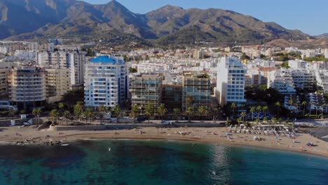 drone shot paralleling sideways, filming the beach in marbella, spain