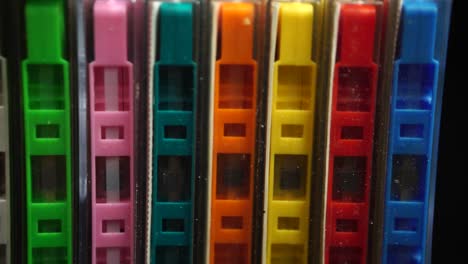 collection of colored audio cassette tapes in boxes, close up dolly shot