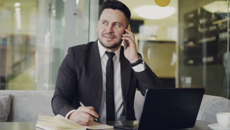 businessman on a phone call in a cafe