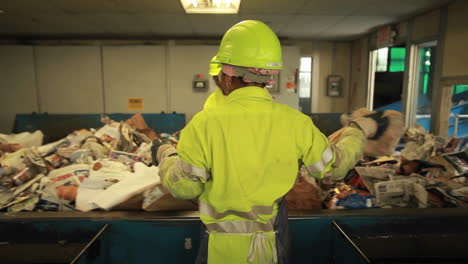 workers sort trash at a recycling center