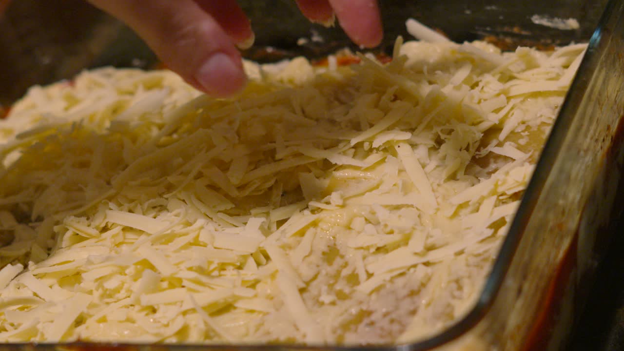 Cooking a Delicious Lasagna: Adding the Final Cheese Topping