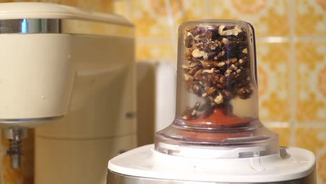 grinding nuts on an electric grinder. closeup.