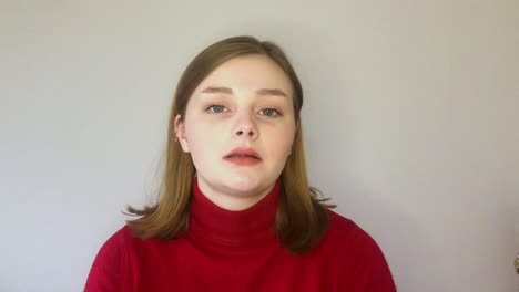 female young student greeting and talking directly to the camera