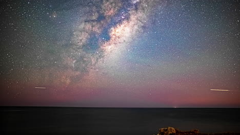 hyper lapse of the milky way galaxy, long exposure, moving across sky, star trails, aeroplane flying, starry sky, wide angle, static