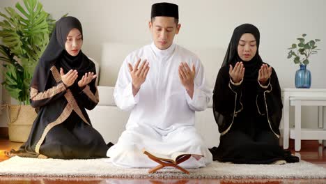 asian muslim family praying and prostrating at home