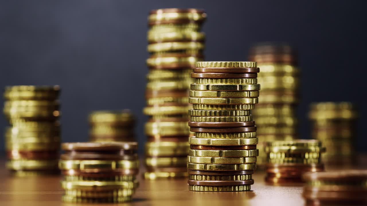 Stacked coins rise one by one in fluid stop motion animation, symbolizing financial growth and success