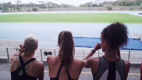 athletes watching a track and field event