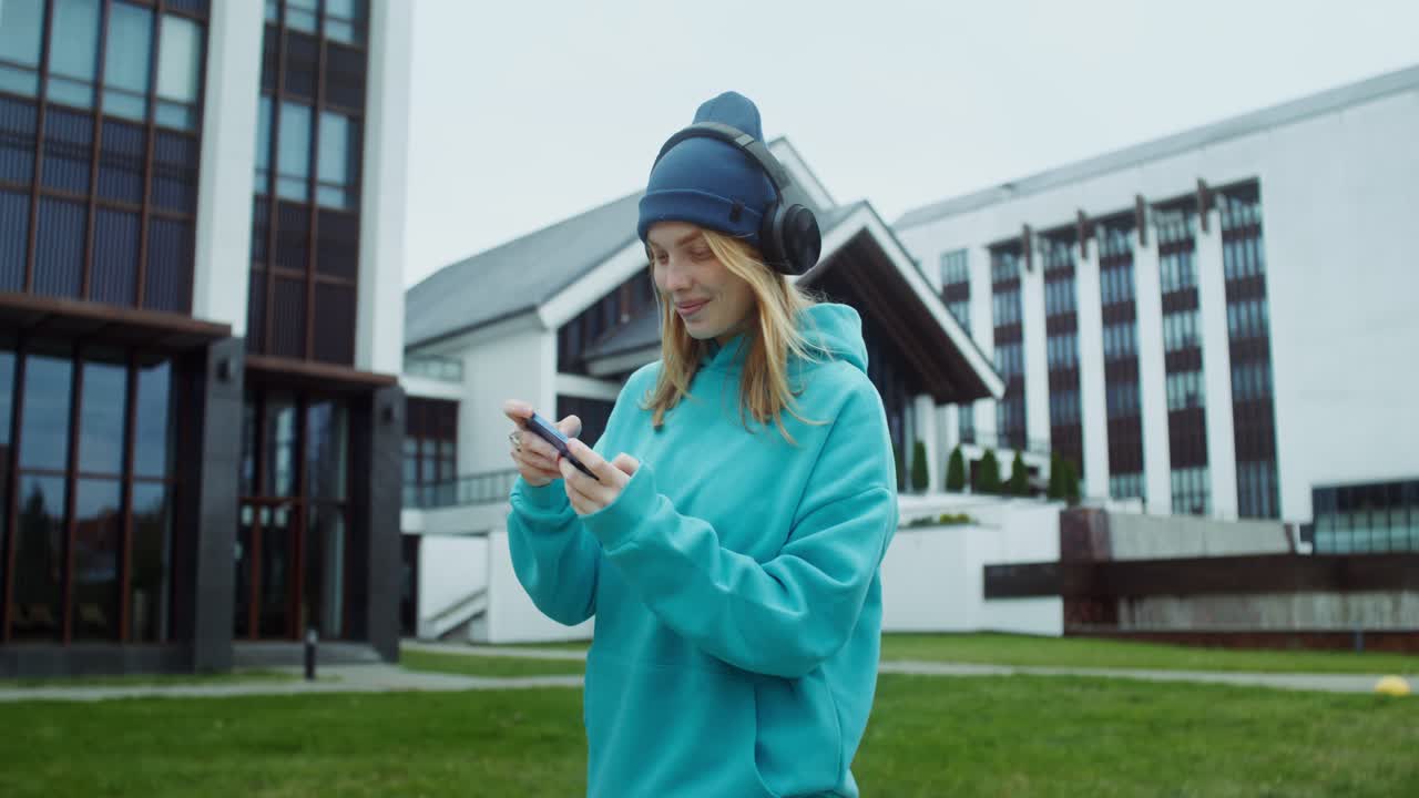 Girl playing game on her smartphone in the university park