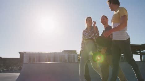 happy caucasian woman and two male friends, walking, talking and spending time together on sunny day