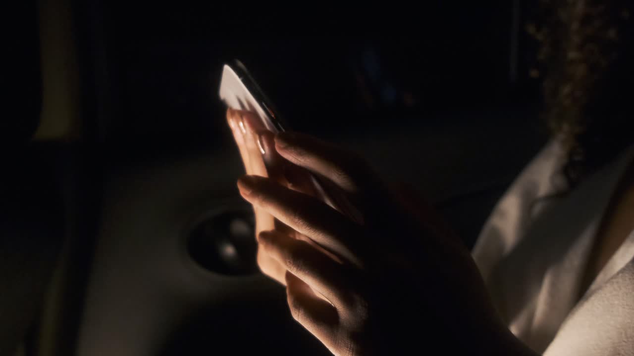 Hands using a phone in the dark | Premium Stock Video Footage
