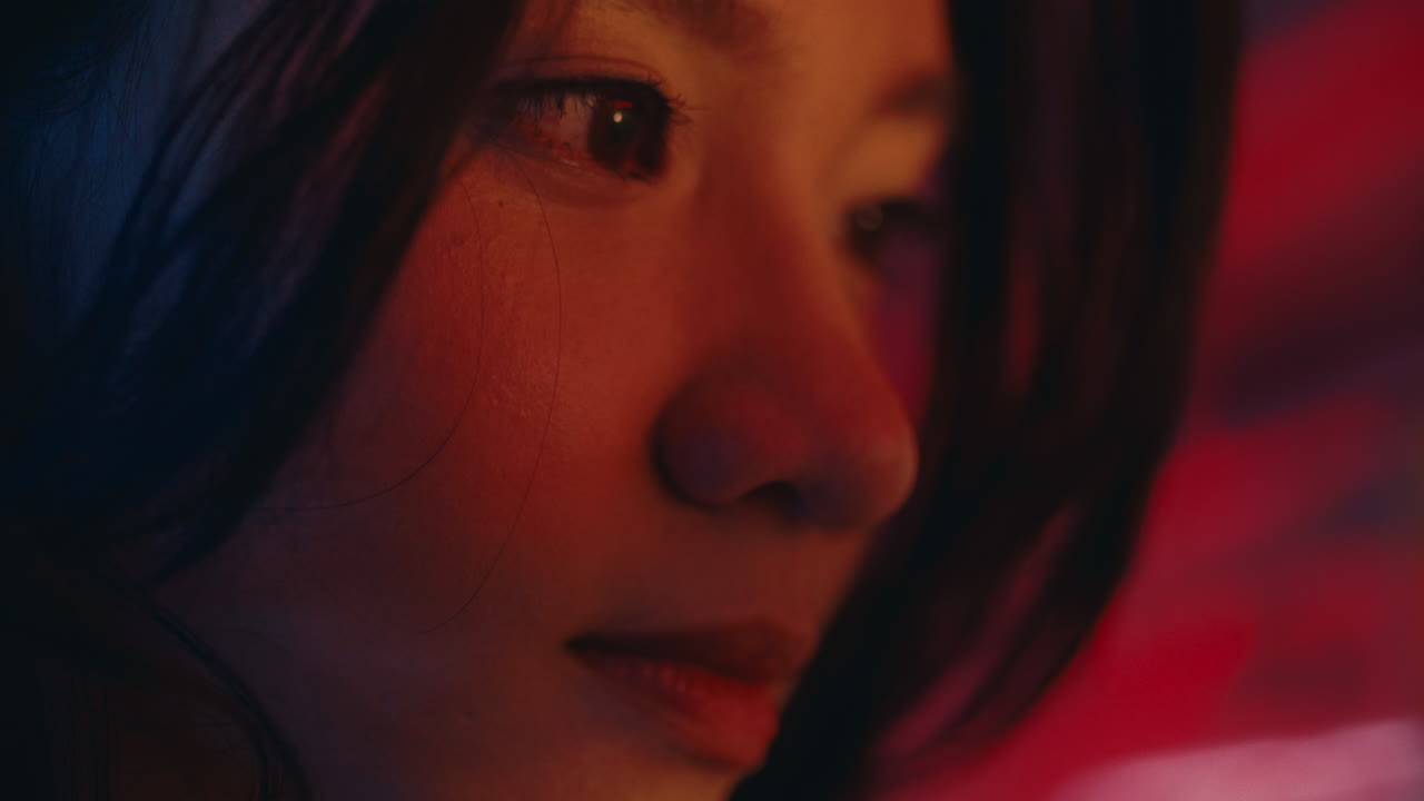Close-up portrait of a woman in neon light