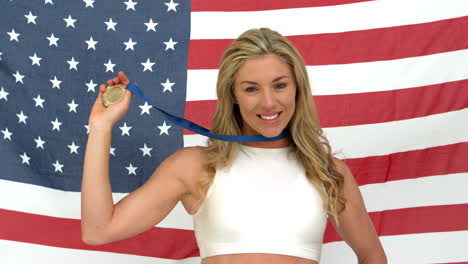 woman smiling with medal in hands