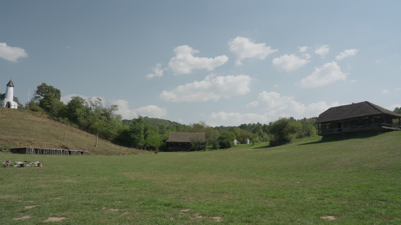 A beautiful white dream catcher swaying gently in the wind on a farm, adding a touch of serenity and boho charm to the rustic countryside setting.