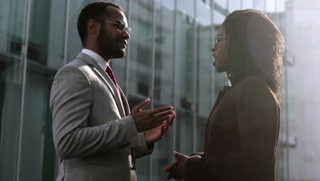 two young people shaking hands outdoor