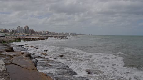 Mar-del-Plata-City-Coastline-with-Waves-Breacking-on-Breakwater,-Argentina