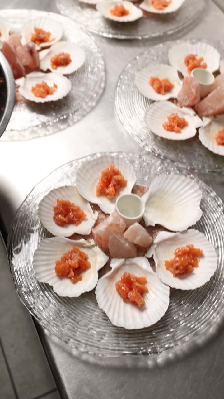 Chef Preparing Plated Scallops with Salmon