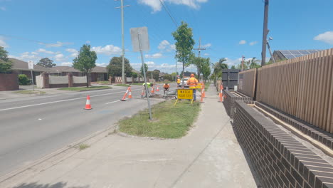 local-road-workers-and-watch-your-step-sign-and-witches-hats