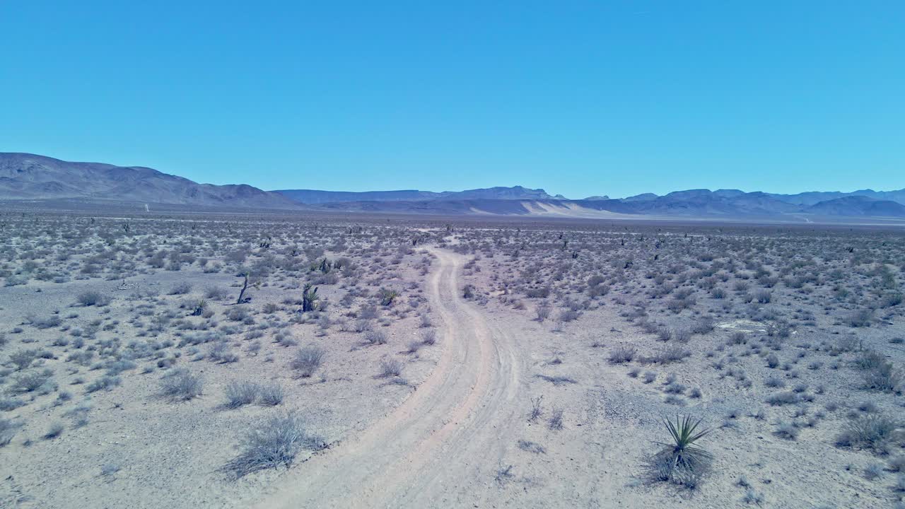 Drone forward tracking over desert road near las vegas nevada