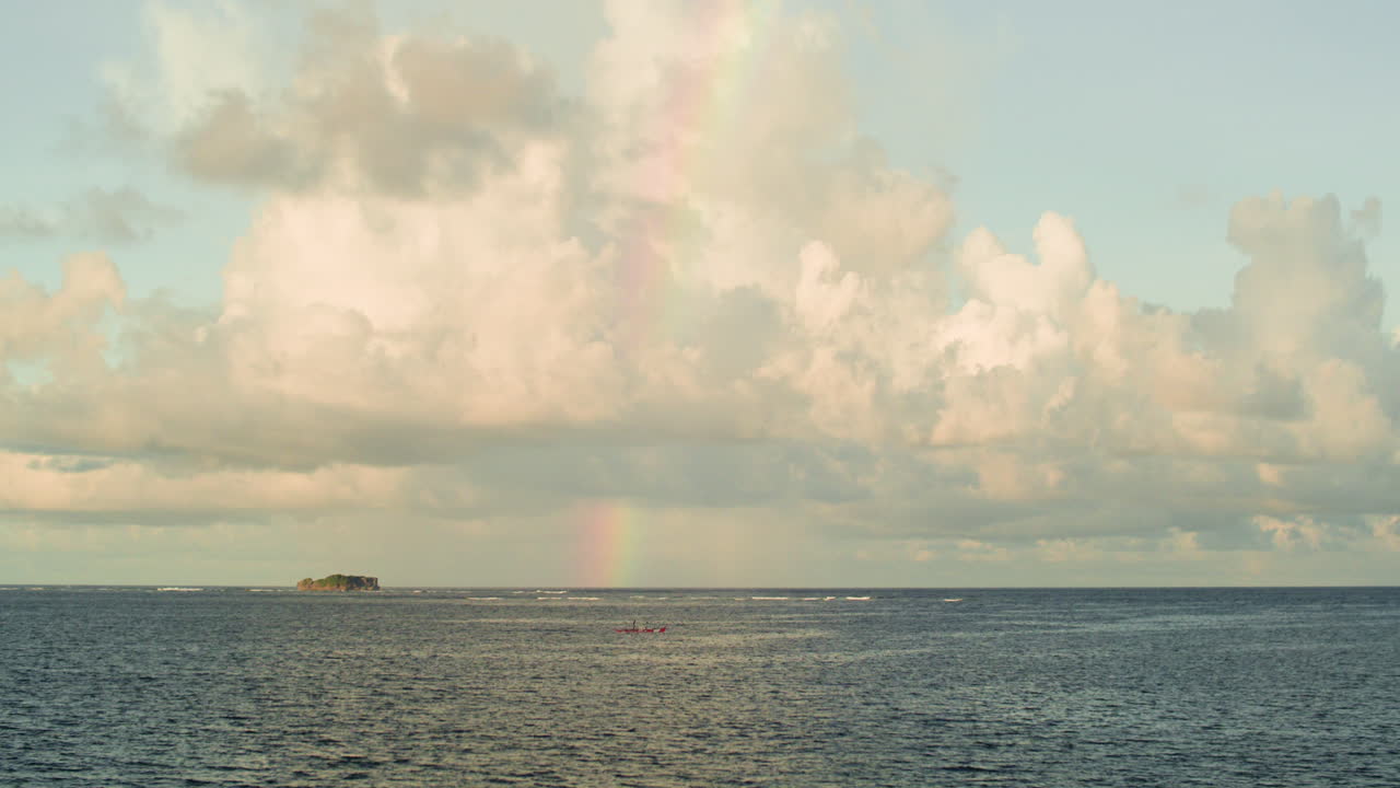 A cloudy afternoon view of a rainbow from Catangnan Bridge in Siargao, Philippines.