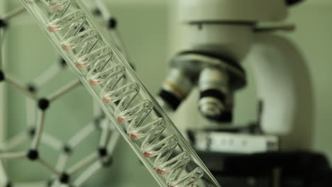 scientific laboratory setup with dna helix model and microscope