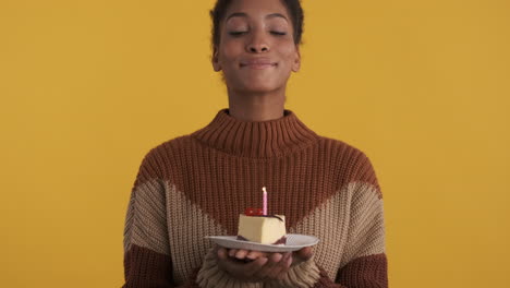 young lady making a wish and blow the candle