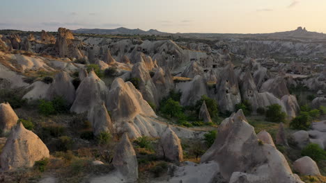 Epic-cinematic-drone-shot-going-through-the-fairy-chimneys-and-the-rocks-in-Cappadocia,-Turkey