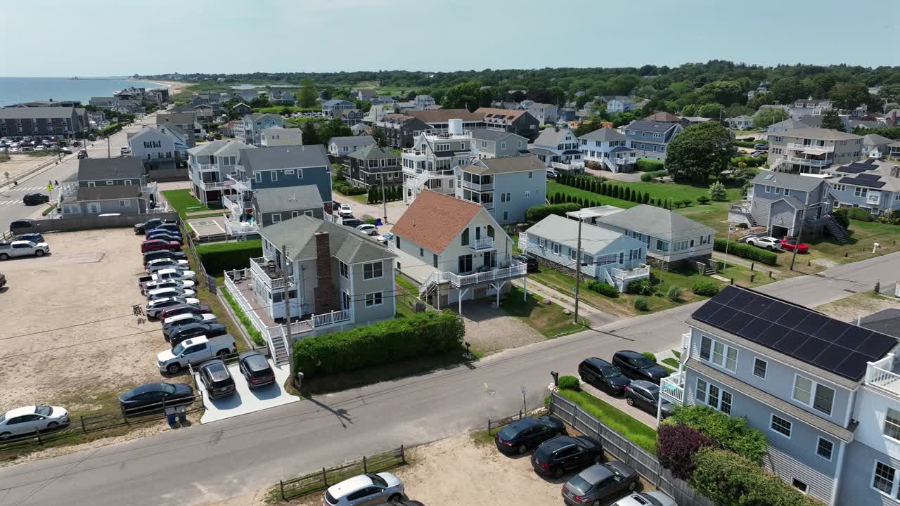 Parking area at beach Misquamicut in Rhode Island during sunny day. Aerial flyover. Beach houses in America
