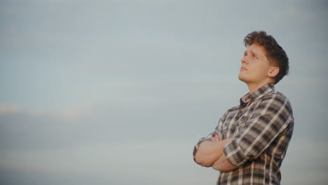 Young-Farmer-With-Arms-Crossed-Against-Sky