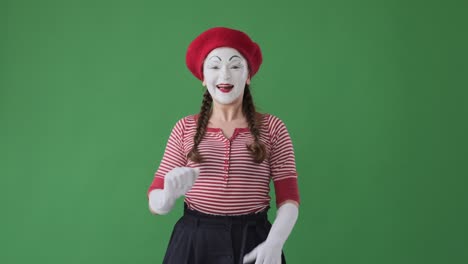 mime woman waving hand over green background