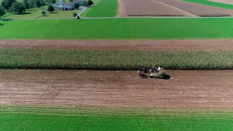 amish farmers harvesting there fall crops as seen by drone