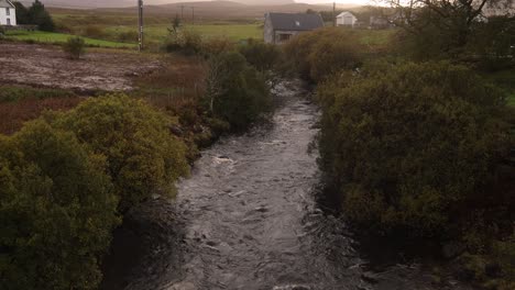 river-flowing-through-small-quaint-village-in-the-countryside-of-Isle-of-Skye,-hIghlands-of-Scotland