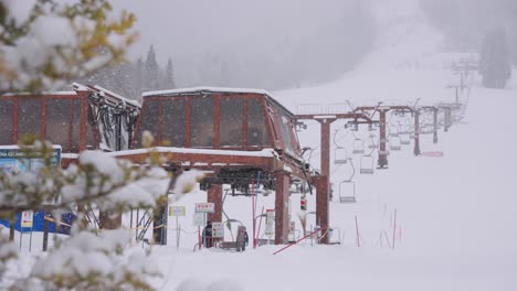 snow falling over ski field on winter day in gifu japan, slow motion establishing shot