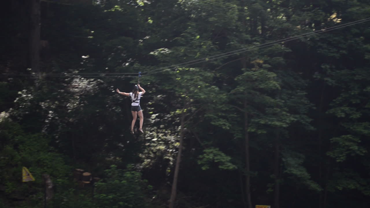 The girl flies through the river. Shooting in the summer