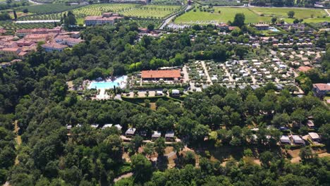 Aerial-Shot-of-Weekend-Glamping-Resort-Campsite-Near-Lake-Garda,-Italy