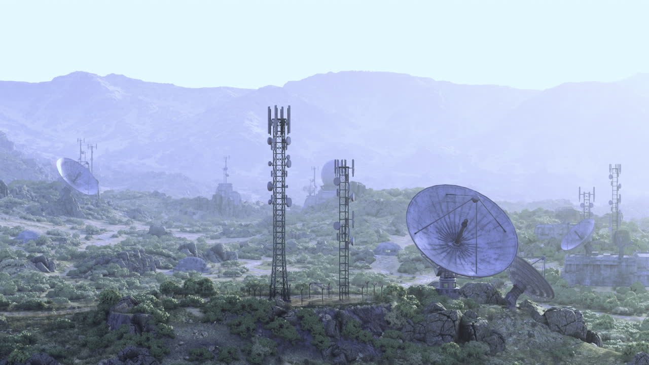 Communication towers amidst mountains during early morning light