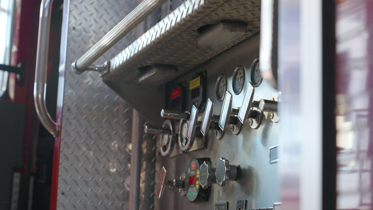 Fire truck or engine close up on panel of gauges and water pump pressure controls. Truck vehicle parking ready to go into fire or rescue mission. Firefighter station. Emergency response. Chrome clocks
