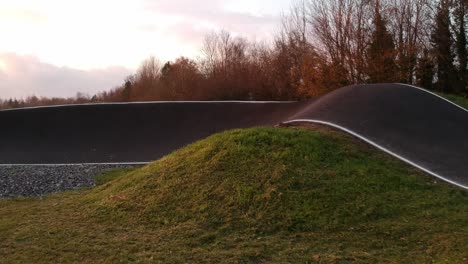 eboarder riding around a bmx pump track