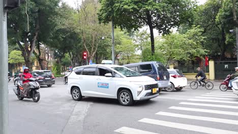 vehicles and pedestrians navigating a city crossroad