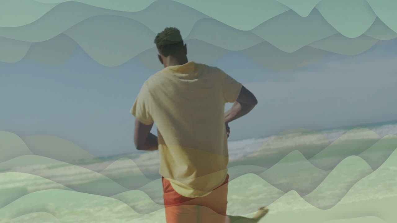 Running on beach, man with animation of abstract wave patterns in scene