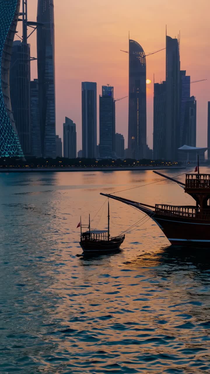 A stunning sunset cityscape video captures skyscrapers and boats on water from a low angle