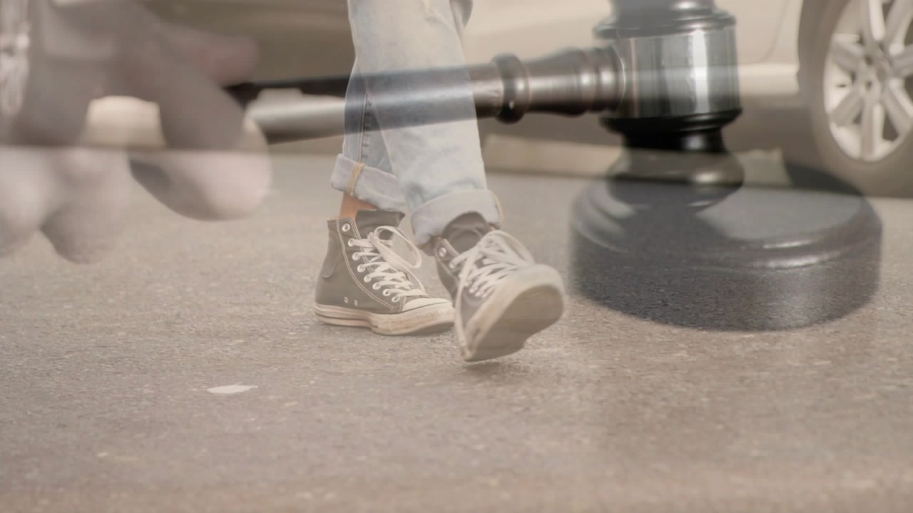 Man walking in jeans as transparent legal gavel syncing with footfalls illustrating justice