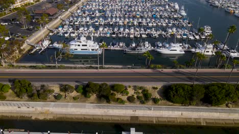 sweeping overview of yachts and boats docked in harbor behind road