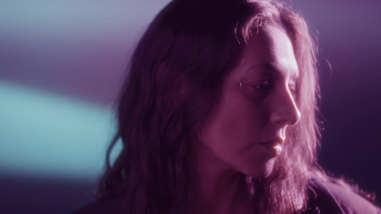 Pensive Woman Looking away under Soft Multicolored Neon Glow