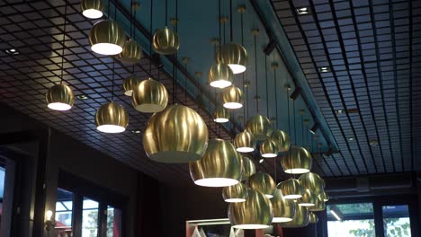 modern gold pendant lights in restaurant interior